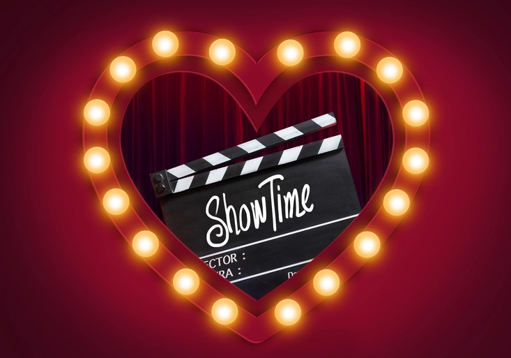 Showtime.Handwriting on film slate.storytelling inspiration Screenwriting and Filmmaking for Love story in valentine's day.Broadway theatre, show performance in the background.