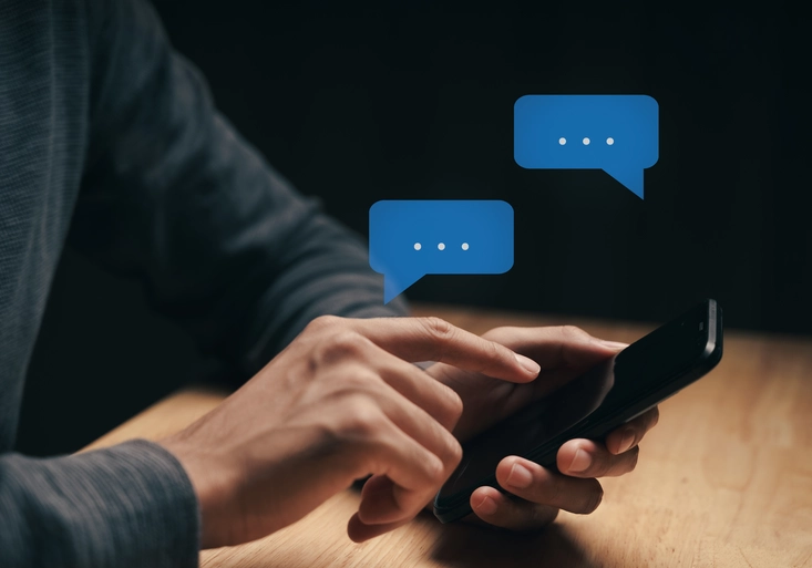 Young man using smartphone typing, chatting conversation with pop up chat box icons. Social Network, technology concept