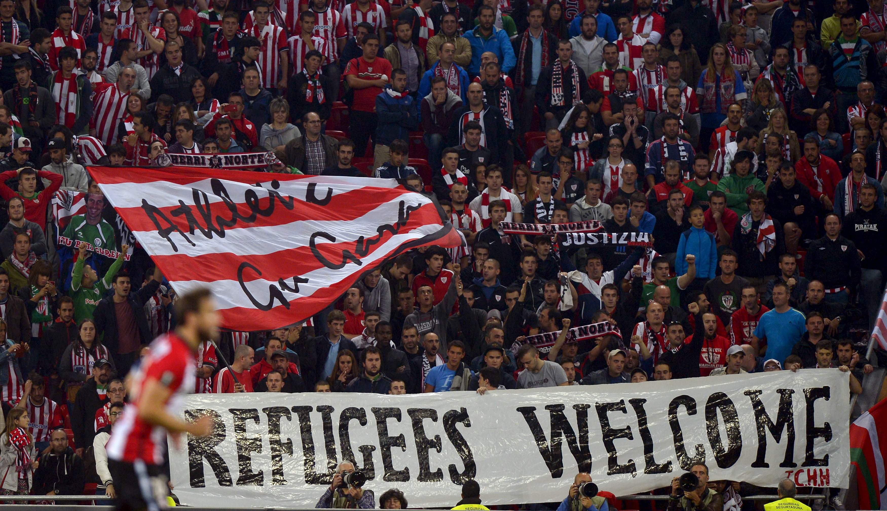 Athletic Bilbao fans from the Herri Norte section hold up a sign reading Refugees Welcome during their UEFA Europa League Group L Group Stage soccer match against Augsburg at San Mames stadium in Bilbao, northern Spain, September 17, 2015. Athletic won 3-1. REUTERS/Vincent West