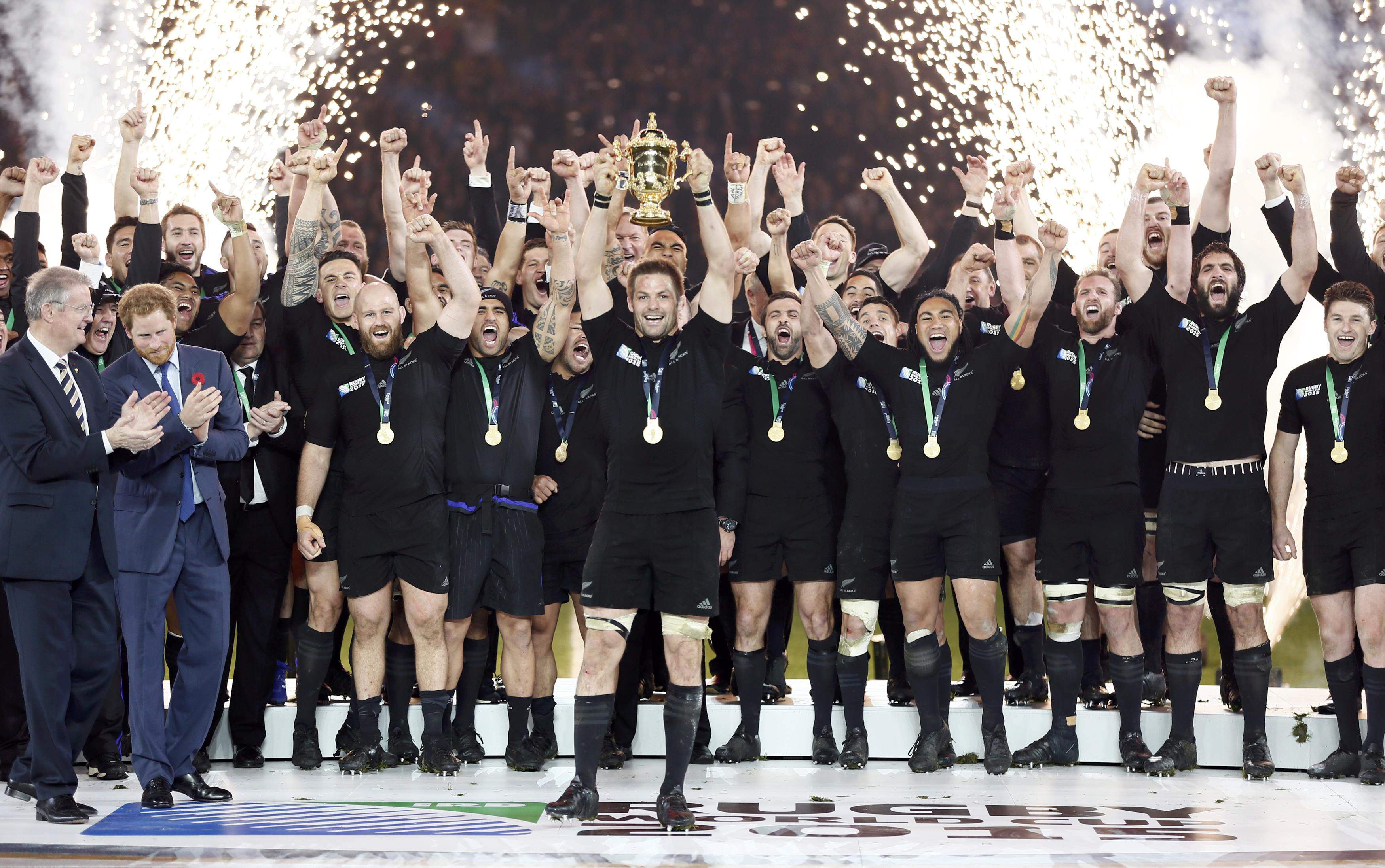 Prince Harry of Britain (2nd L) applauds as Richie McCaw of New Zealand (C) holds up the Webb Ellis trophy after winning the Rugby World Cup Final against Australia at Twickenham in London, October 31, 2015. REUTERS/Stefan Wermuth   Picture Supplied by Action Images