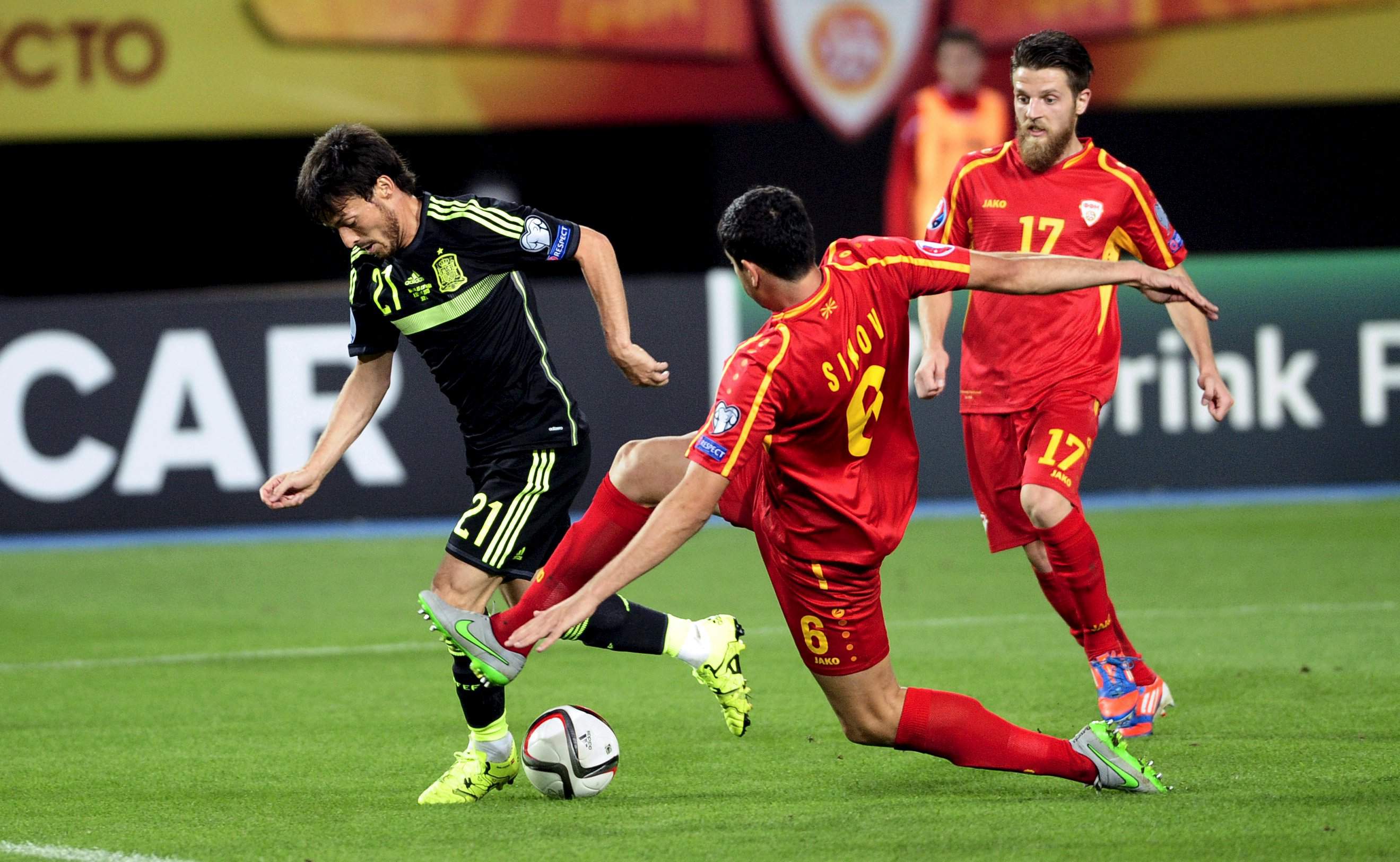 Spain David Silva  (L) fight for the ball with Macedonian Vance Shikov during their Euro 2016 qualification soccer match at Skopje city stadium ,Macedonia September 8,2015. REUTERS/Ognen Teofilovski
