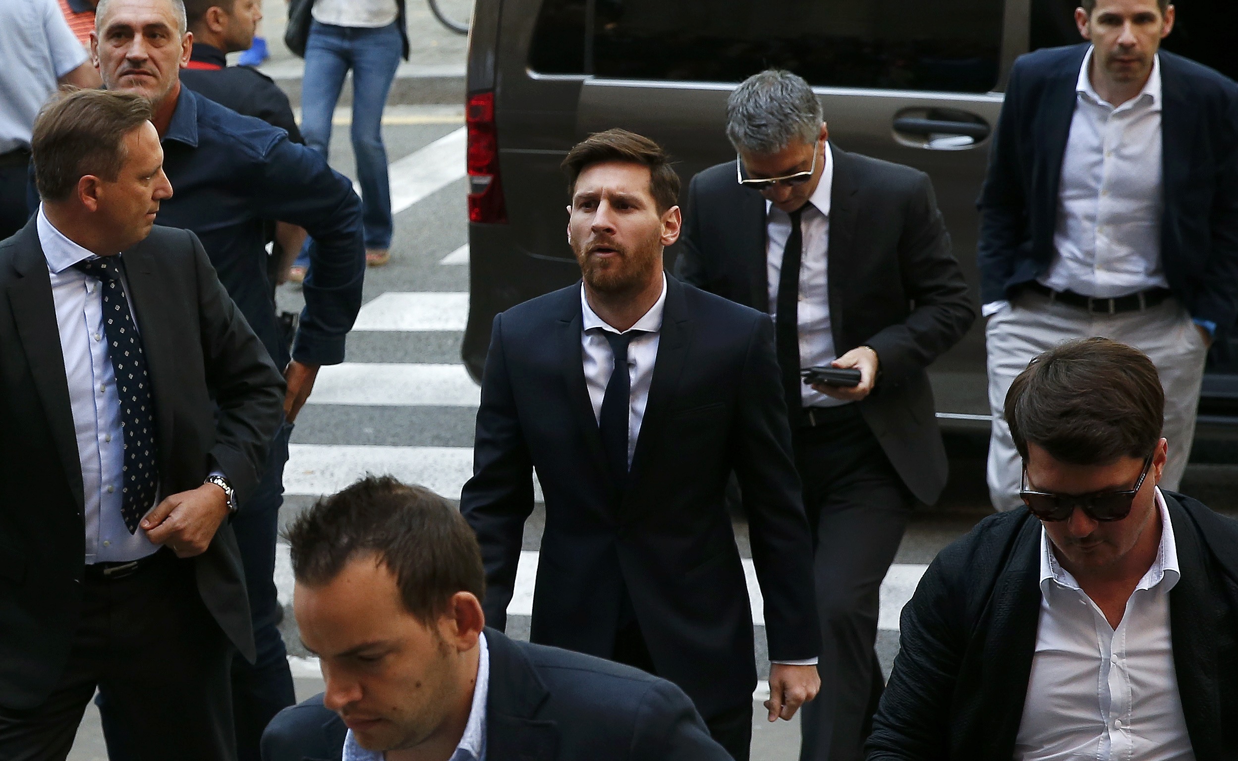 Barcelona's Argentine soccer player Lionel Messi (C) arrives to court with his father Jorge Horacio Messi (3rd R) to stand trial for tax fraud in Barcelona, Spain, June 2, 2016. REUTERS/Albert Gea