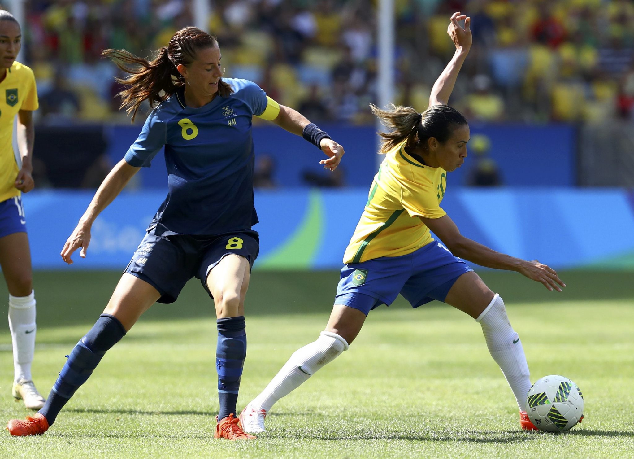 2016 Rio Olympics - Soccer - Semifinal - Women's Football Tournament Semifinal Brazil v Sweden - Maracana - Rio de Janeiro, Brazil - 16/08/2016. Marta (BRA) of Brazil and Lotta Schelin (SWE) of Sweden (L) compete. REUTERS/Leonhard Foeger FOR EDITORIAL USE ONLY. NOT FOR SALE FOR MARKETING OR ADVERTISING CAMPAIGNS.